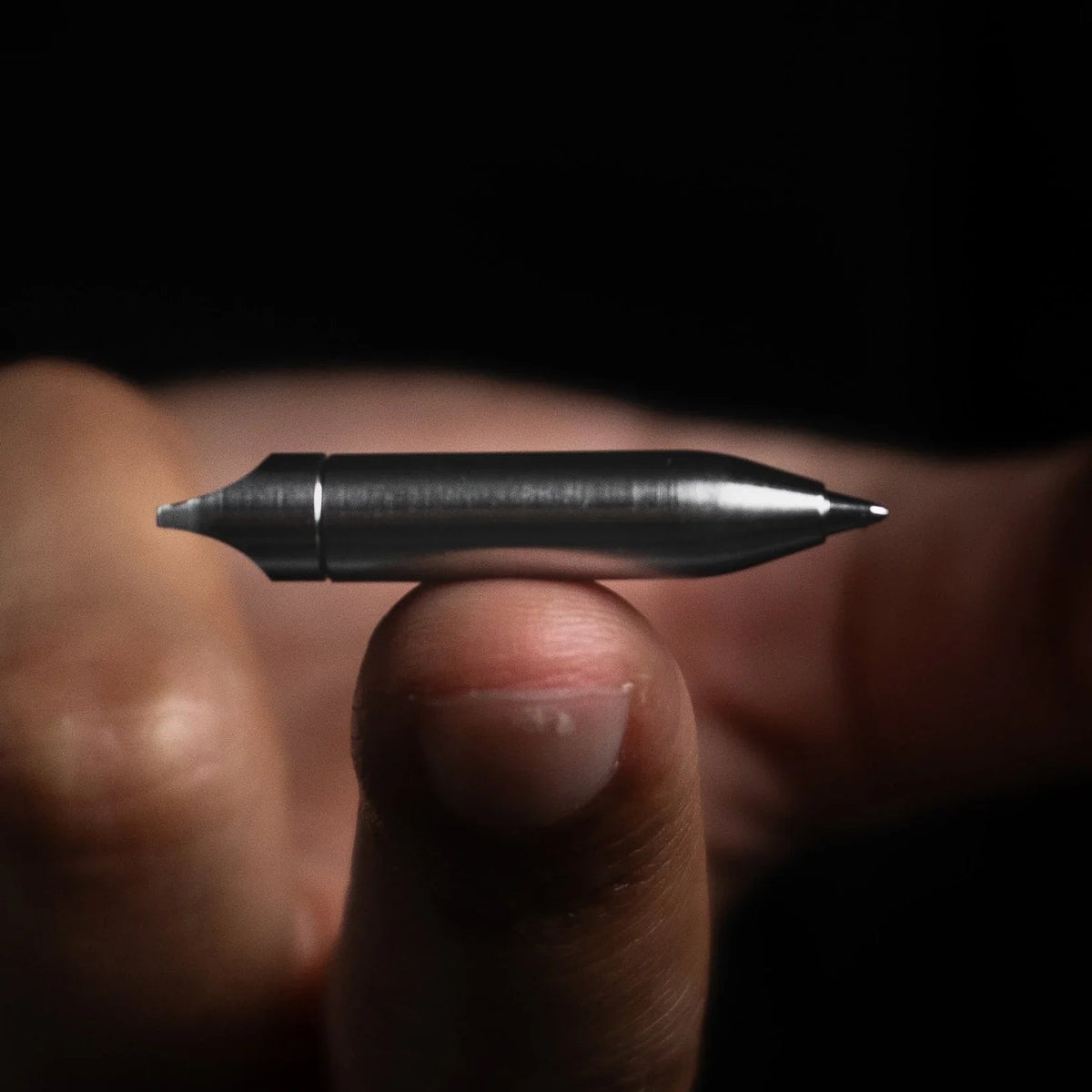 Compact stainless steel pen balanced on fingertip, Gear Carry everyday carry accessory