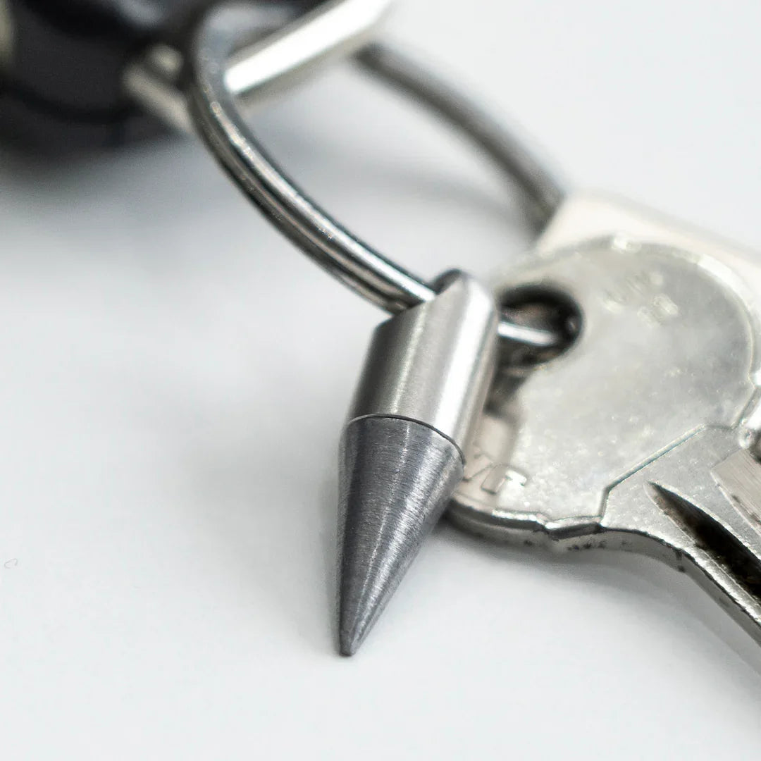 Stainless steel keychain spike tool attached to a metal key on a silver key ring